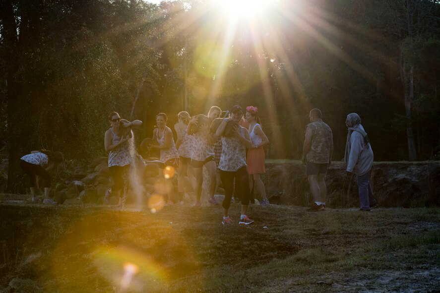 Participants carry sandbags to the first obstacle of the Moody Mud Run, May 6, 2017, in Ray City, Ga. The Fourth Annual Moody Mud consisted of both adult and child course that challenged more than 600 participants with obstacles over 4.2 miles. (U.S. Air Force photo by Staff Sgt. Eric Summers Jr.)
