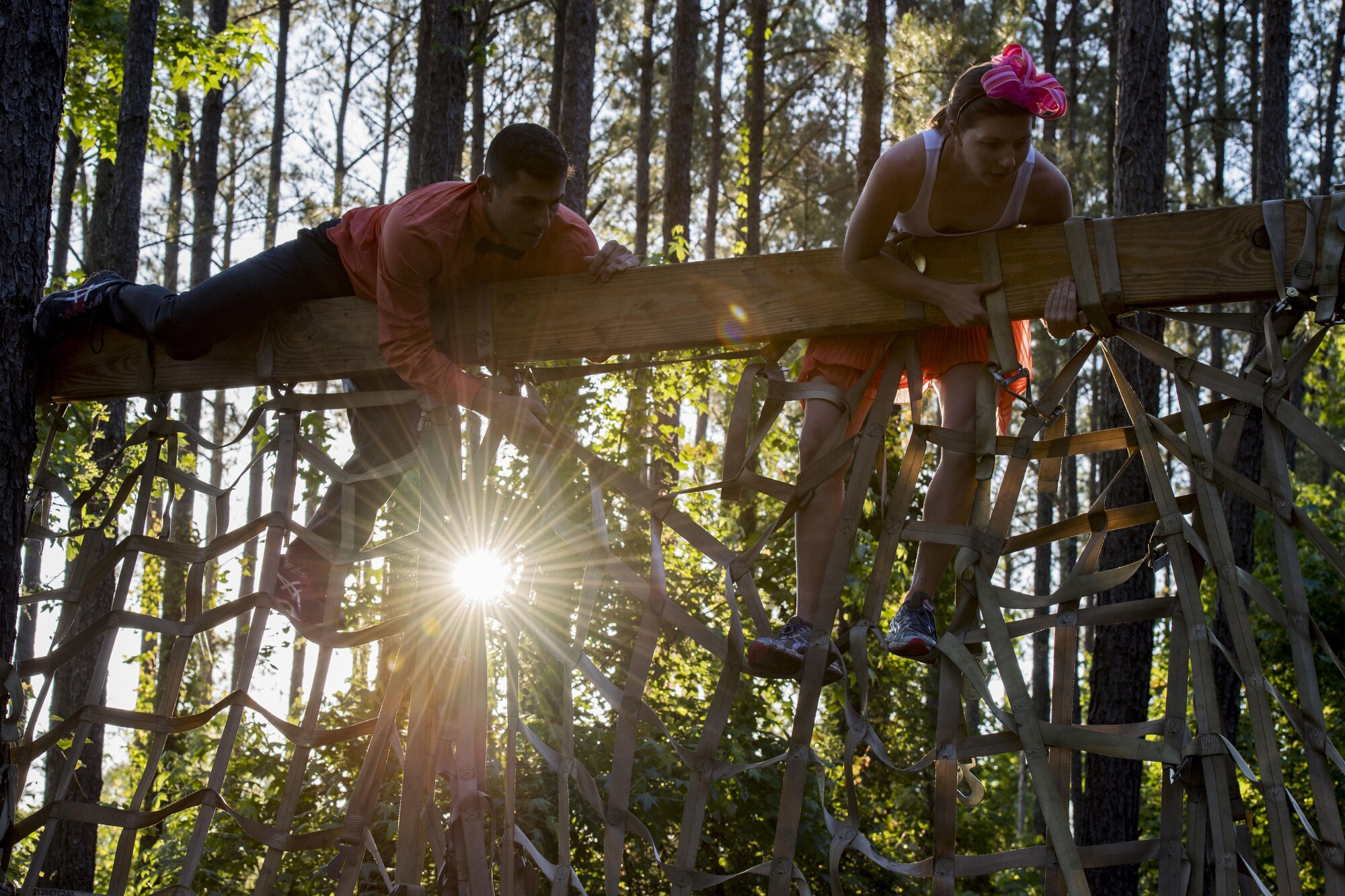 Participants maneuver themselves over a rope wall during the Moody Mud Run, May 6, 2017, in Ray City, Ga. The Fourth Annual Moody Mud consisted of both adult and child course that challenged more than 600 participants with obstacles over 4.2 miles. (U.S. Air Force photo by Staff Sgt. Eric Summers Jr.)