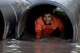 A Moody Mud Run participant crawls though a tube of murky water, May 6, 2017, in Ray City, Ga. The Fourth Annual Moody Mud consisted of both adult and child course that challenged more than 600 participants with obstacles over 4.2 miles. (U.S. Air Force photo by Staff Sgt. Eric Summers Jr.)