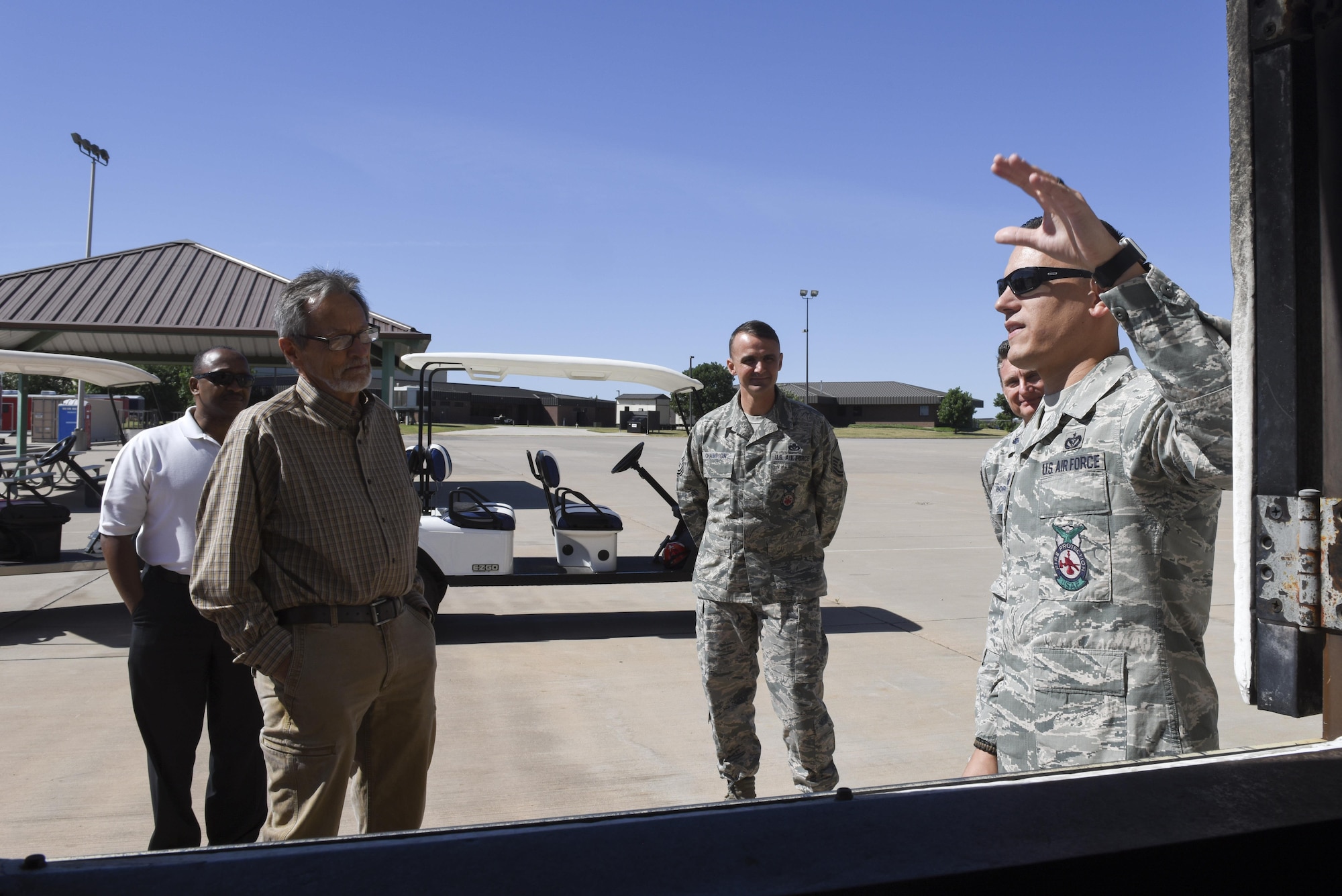 U.S. Air Force Staff Sgt. Alexander Rodriguez, 312th Training Squadron instructor, speaks to Emmett Corker, Northridge Baptist Church pastor, about firefighter training at the Louis F. Garland Department of Defense Fire Academy on Goodfellow Air Force Base, Texas, May 4, 2017. The tour helped increase local ministers knowledge of the base mission. (U.S. Air Force photo by Airman 1st Class Chase Sousa/Released)