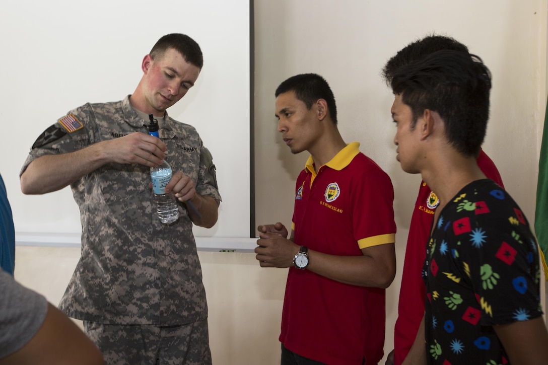 U.S. Army Sgt. Elliot Arens demonstrates an emergency water filtration procedure to members of Philippine disaster relief agencies during a subject matter expert exchange for Balikatan 2017 on Fort Magsaysay in Santa Rosa, Nueva Ecija, May 4, 2017. Balikatan is an annual U.S.-Philippine bilateral military exercise focused on a variety of missions including humanitarian and disaster relief, counterterrorism, and other combined military operations. 