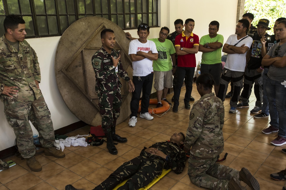 Philippine Army Pfc. Arnold Ambrocio explains how to transport a person with a head or neck injury during a subject matter expert exchange for Balikatan 2017 at Fort Magsaysay in Santa Rosa, Nueva Ecija, May 4, 2017. Balikatan is an annual U.S.-Philippine bilateral military exercise focused on a variety of missions including humanitarian and disaster relief, counterterrorism, and other combined military operations. 