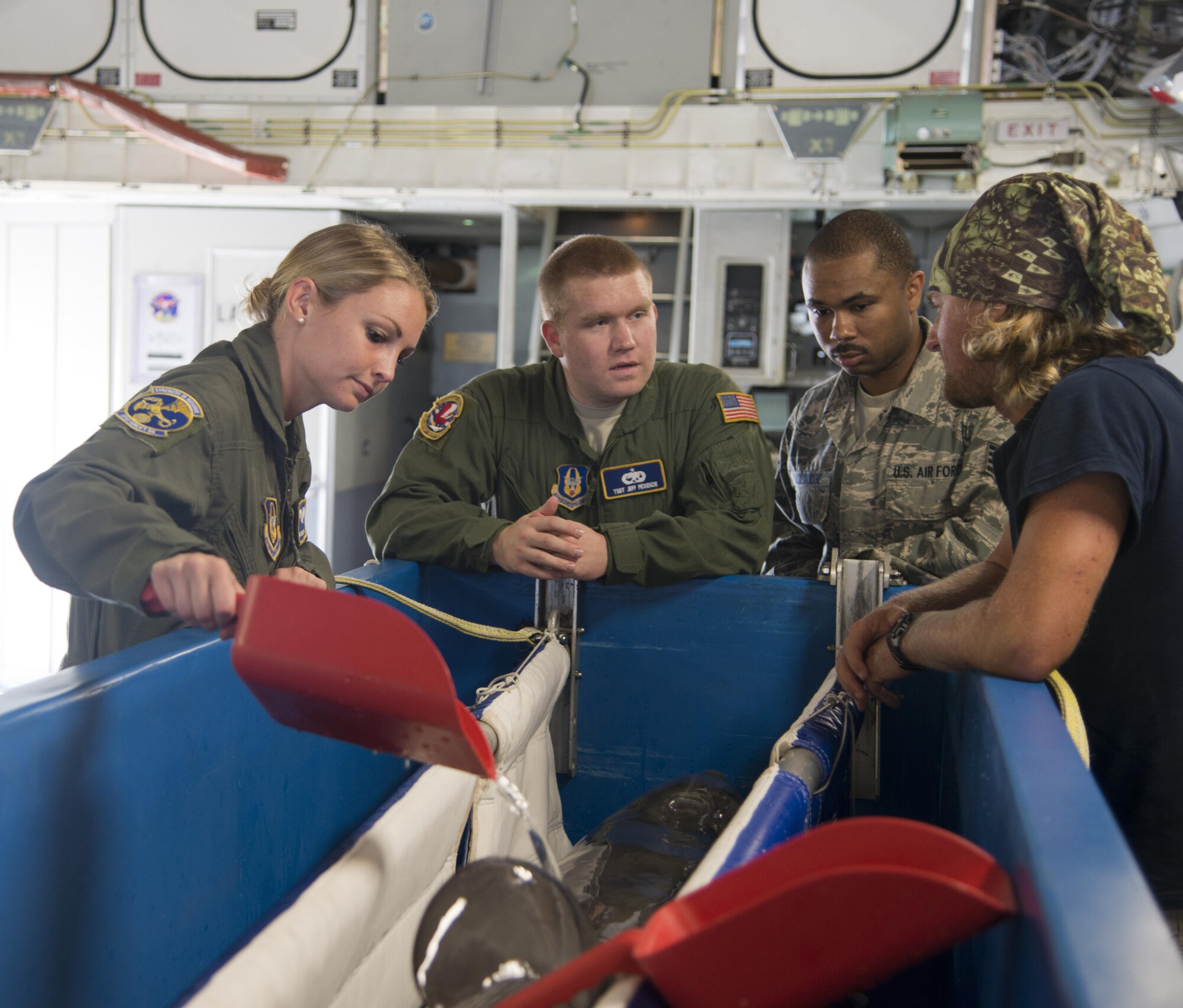 Airmen from the 301st Airlift Squadron and 945th Aircraft Maintenance Squadron learn about Maya, a dolphin from the U.S. Navy Marine Mammal Program, as they prepare for a mission from Naval Air Station Key West, Fla., to San Diego April 28, 2017. The 301st AS transported four Bottlenose Dolphins and their handlers to the U.S. Naval Marine Mammal Program where they train to assist the U.S. Navy with locating mines and enemy swimmers. (U.S. Air Force photo/Staff Sgt. Nicole Leidholm)