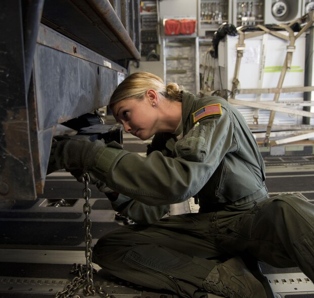 Staff Sgt. Suzannah Grant, 301st Airlift Squadron, looks for a way to tie down a government vehicle during a mission from Key West, Fla., to San Diego April 28, 2017. The 301st AS transported four Bottlenose Dolphins and their handlers to the U.S. Naval Marine Mammal Program where they train to assist the U.S. Navy with locating mines and enemy swimmers. (U.S. Air Force photo/Staff Sgt. Nicole Leidholm)