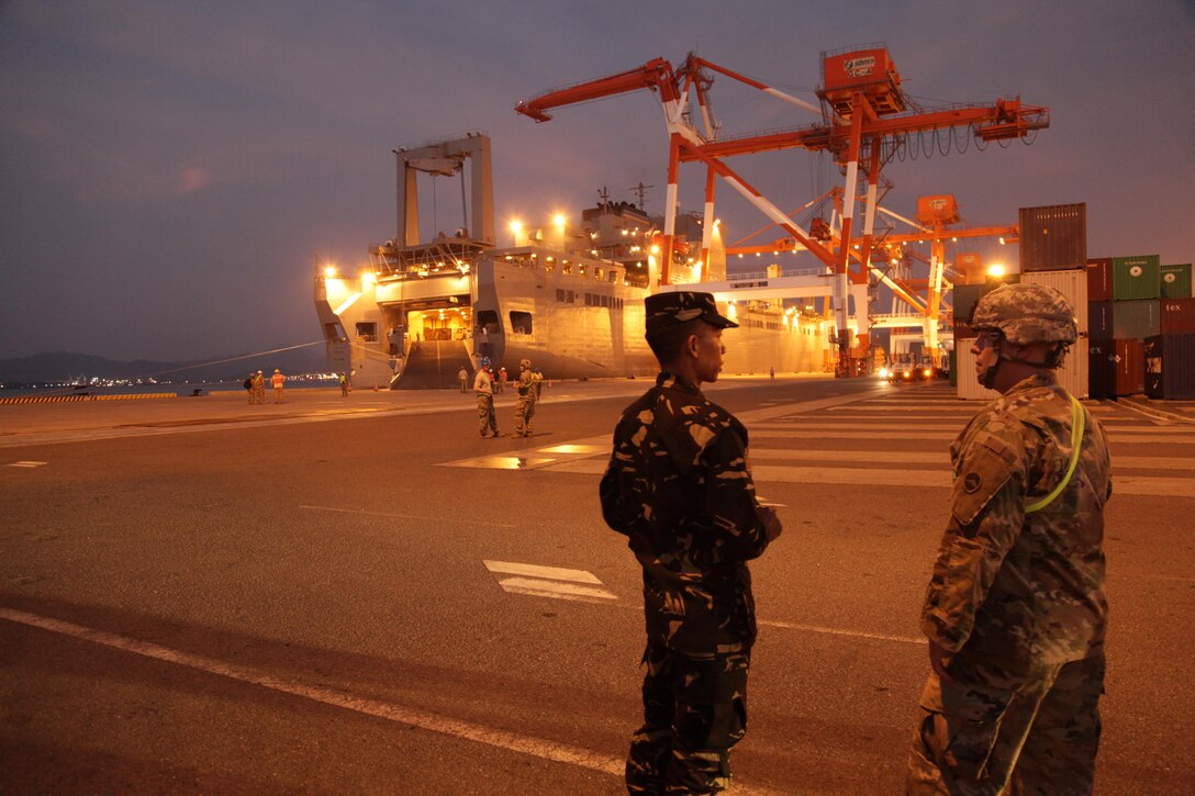 A U.S. Soldier talks with a Philippine service member during port operations in support of Balikatan 2017 at Subic Bay, Zambales, April 30, 2017. Balikatan is an annual U.S.-Philippine bilateral military exercise focused on a variety of missions, including humanitarian assistance and disaster relief, counterterrorism and other combined military operations.