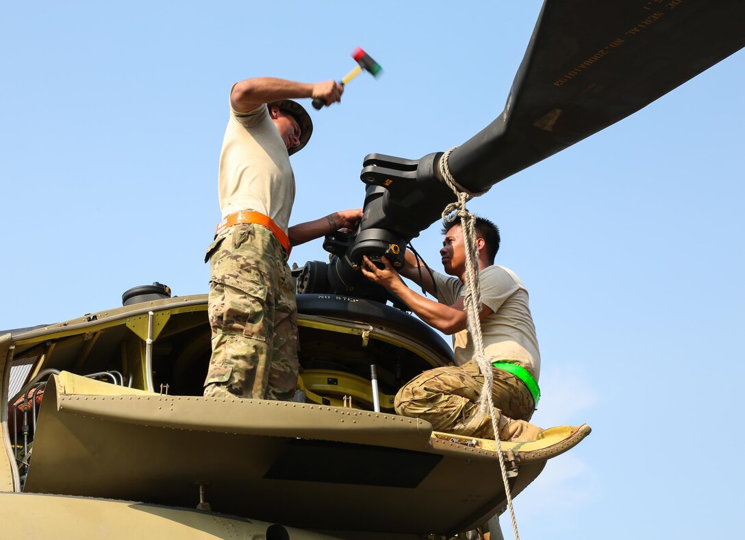 U.S. Army Sgt. Johned Cabuco and Spc. Abraham Romero attach a rotor to a CH-47 Chinook helicopter during port operations in support of Balikatan 2017 at Subic Bay, Zambales, May 1, 2017. Cabuco and Romero are with the 25th Combat Aviation Brigade, 25th Infantry Division. Balikatan is an annual U.S.-Philippine bilateral military exercise focused on a variety of missions, including humanitarian assistance and disaster relief, counterterrorism, and other combined military operations. 