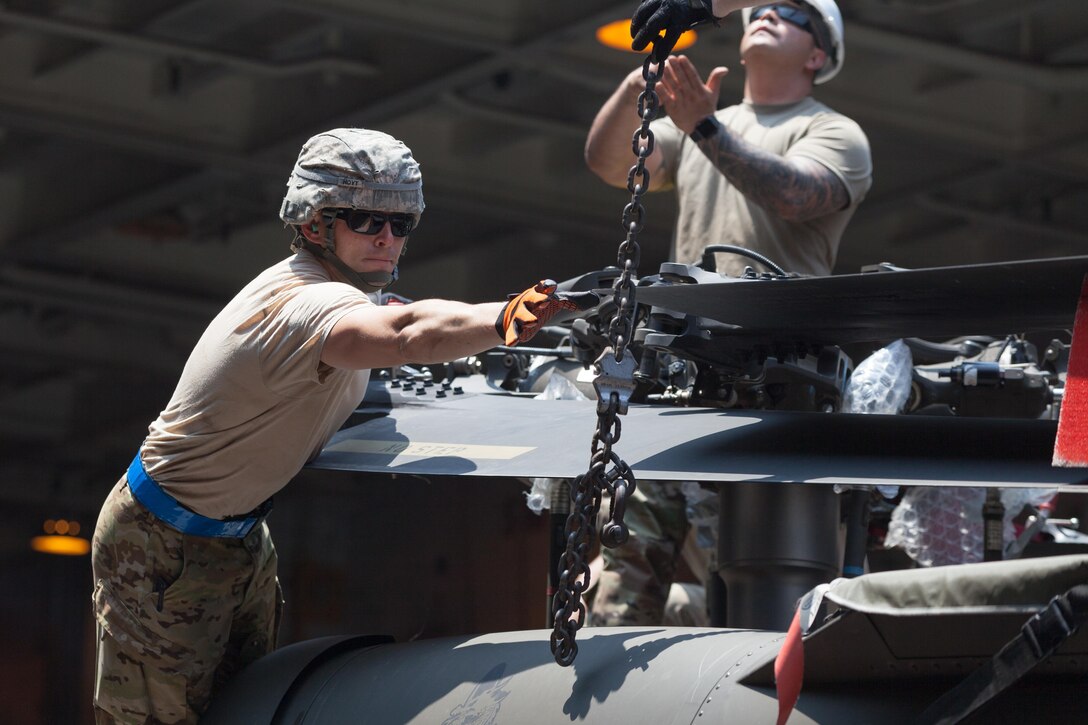 U.S. Soldiers prepare a CH-47 Chinook helicopter to be hoisted off USNS Fisher (T-AKR 301) during Balikatan 2017 in Subic Bay, Zambales, May 1, 2017 Balikatan is an annual U.S.-Philippine bilateral military exercise focused on a variety of missions, including humanitarian assistance and disaster relief, counterterrorism, and other combined military operations. 