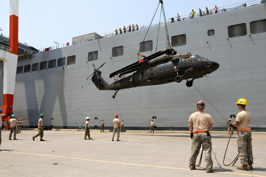 U.S. Soldiers guide a UH-60 Black Hawk off USNS Fisher (T-AKR 301) during port operations in support of Balikatan 2017 at Subic Bay, Zambales, May 1, 2017. Balikatan is an annual U.S.-Philippine bilateral military exercise focused on a variety of missions, including humanitarian assistance and disaster relief, counterterrorism, and other combined military operations.