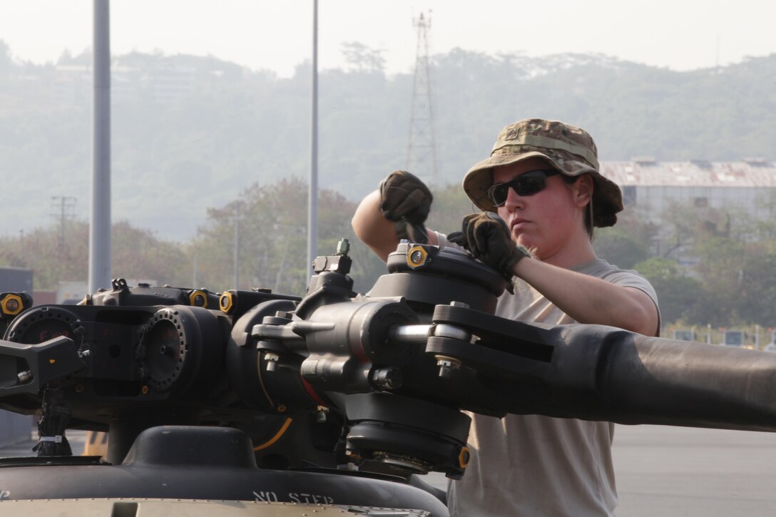 U.S. Army Sgt. Megan St. Pierre, a flight instructor, finishes installing a CH-47 Chinook helicopter rotor blade during port operations for Balikatan 2017 in Subic Bay, Zambales, May 2, 2017. Balikatan is an annual U.S.-Philippine bilateral military exercise focused on a variety of missions, including humanitarian assistance and disaster relief, counterterrorism and other combined military operations.