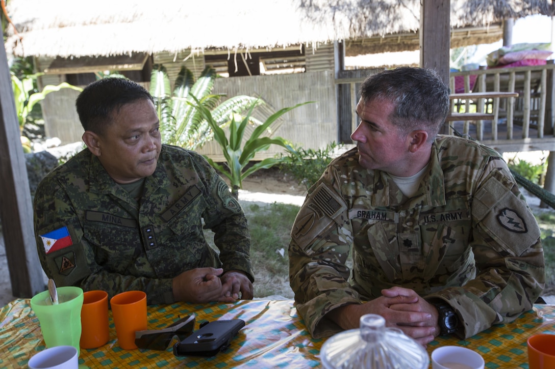Philippine Army Col. Lawrence Mina and U.S. Army Lt. Col. Andrew Graham discuss bilateral training plans during Balikatan 2017 at Calayan Island, Philippines, May 6, 2017. Mina is deputy Assistance Chief of Staff for Training and Education Staff, Philippine Army and Graham is the commander with 3rd Battalion, 25th Aviation Regiment, 25th Combat Aviation Brigade. Balikatan is an annual U.S.-Philippine bilateral military exercise focused on a variety of missions including humanitarian and disaster relief, counterterrorism, and other combined military operations. 