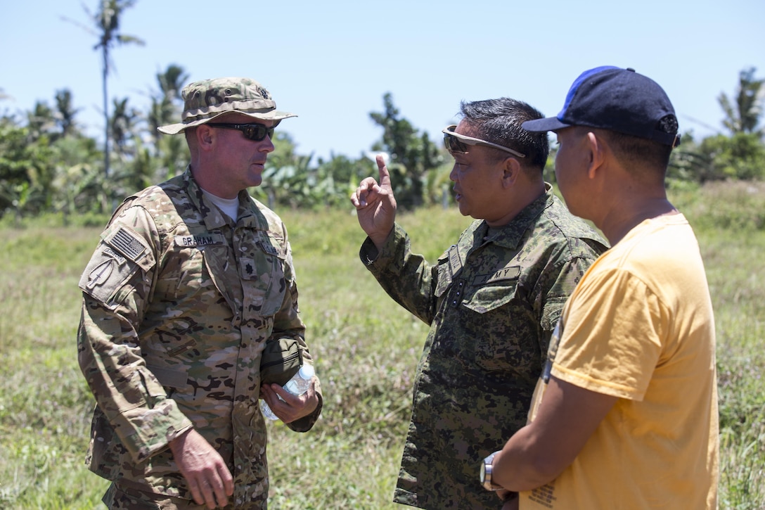 U.S. Army Lt. Col. Andrew Graham, Philippine Army Col. Lawrence Mina and Mayor Alfonso Llopis discuss bilateral training plans during Balikatan 2017 on Calayan Island, Philippines, May 6, 2017. Graham is the commander with 3rd Battalion, 25th Aviation Regiment, 25th Combat Aviation Brigade. Mina is deputy Assistance Chief of Staff for Training and Education Staff, Philippine Army. Llopis is the mayor of Calayan. Balikatan is an annual U.S.-Philippine bilateral military exercise focused on a variety of missions including humanitarian and disaster relief, counterterrorism, and other combined military operations.