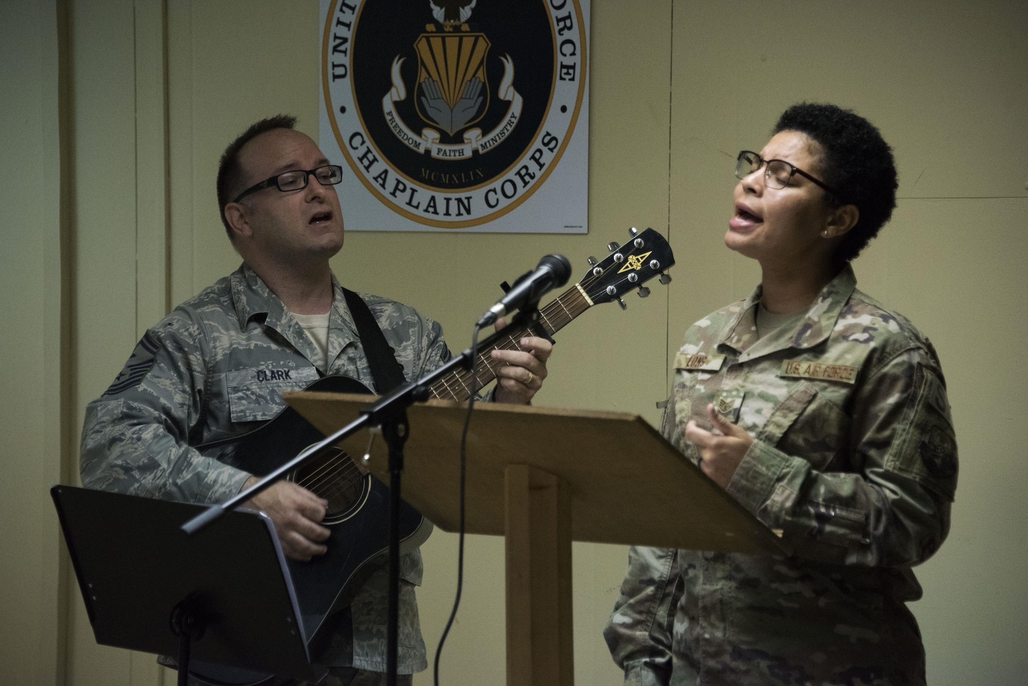 Senior Master Sgt. Robert Clark, a 386th Expeditionary Aircraft Maintenance Squadron first sergeant, and Staff Sgt. Mikele Long, a 386th Expeditionary Security Forces Squadron member, perform their rendition of “Undescribable” during a Faith Works leadership luncheon, at an undisclosed location in Southwest Asia, May 4, 2017. The U.S. Air Force Chaplain Corps recently rolled out the Faith Works campaign to inform Airmen about the overwhelming evidence regarding the positive relationship between spirituality, religion, and health. (U.S. Air Force photo/ Tech. Sgt. Jonathan Hehnly)