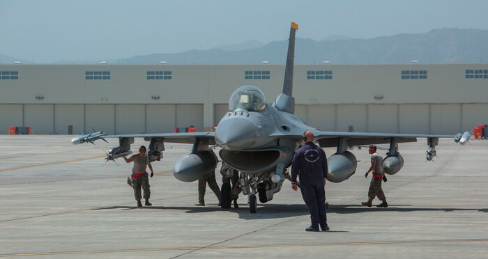 U.S. Air Force Senior Airman Charles Bolles, right, a crew chief with the 35th Aircraft Maintenance Unit from Misawa Air Base, and Masato Ohchi, hot pit operator at Marine Corps Air Station (MCAS) Iwakuni, conduct hot pit refueling on a U.S. Air Force F-16 Fighting Falcon at MCAS Iwakuni, Japan, May 8, 2017. Hot pits are refueling stations usually used in combat to rapidly refuel aircraft while the engines are running. This allows aircraft to return to the fight with minimal delay. (U.S. Marine Corps photo by Pfc. Stephen Campbell)