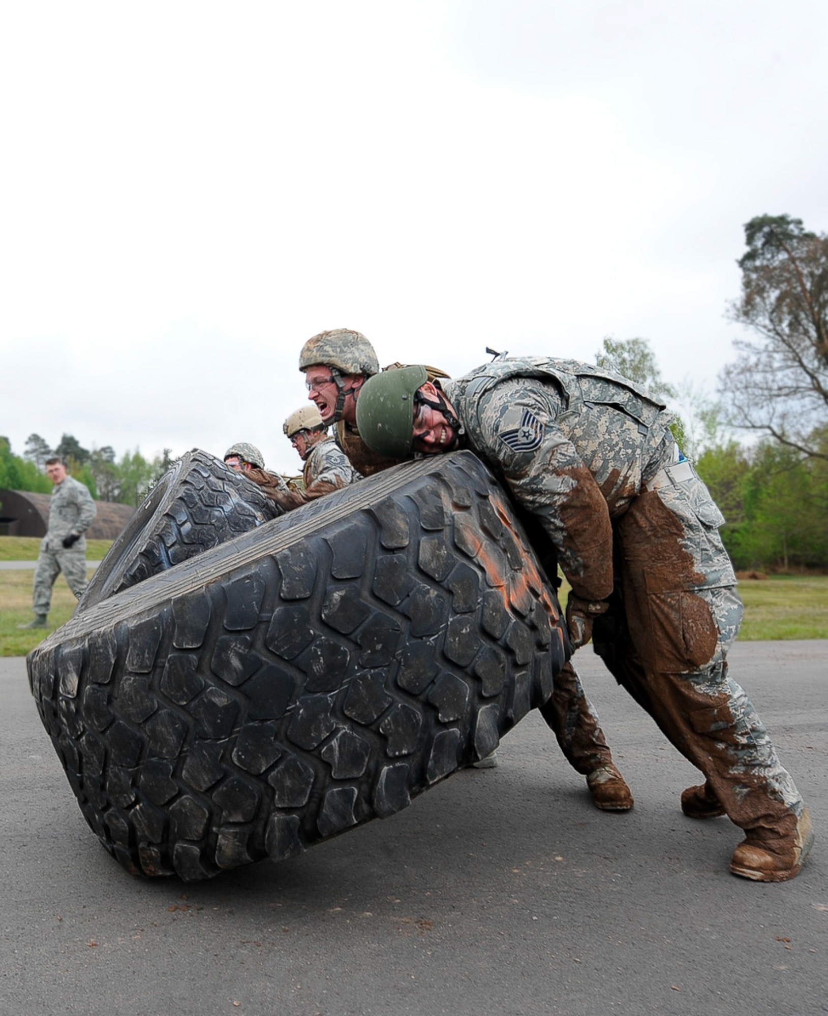 Members from the 435th Contingency Response Group flip tires in an obstacle course during the 435th CRG Olympics on Ramstein Air Base, Germany, May 5, 2017. An obstacle course, Kaiser Sled, and a pallet build were among six events held during the 435th CRG Olympics. (U.S. Air Force photo by Airman 1st Class Savannah L. Waters)