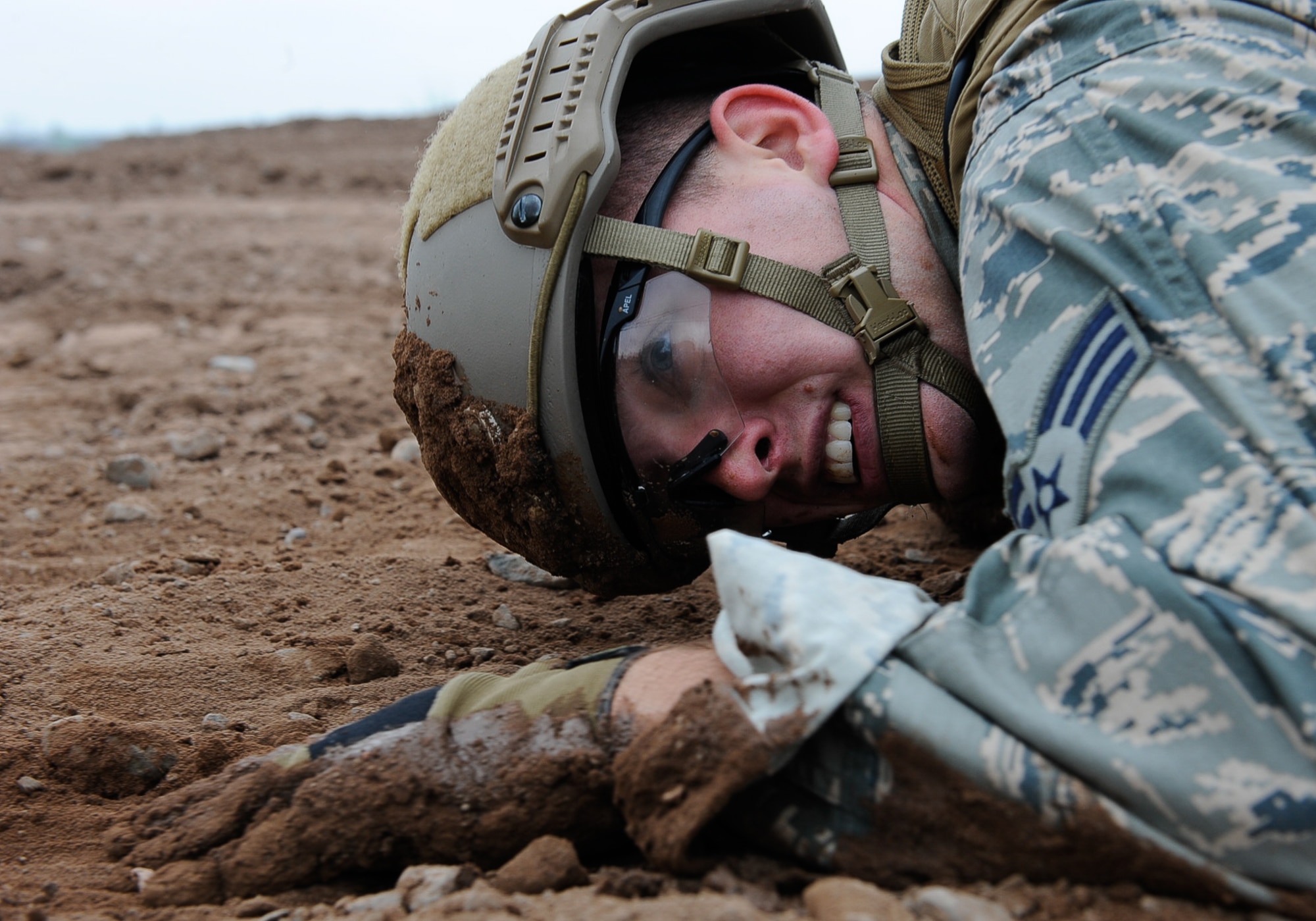 Senior Airman Ryan Daggett, 435th Security Forces Squadron contingency response fire team member, low-crawls while participating in the 435th Contingency Response Group Olympics on Ramstein Air Base, Germany, May 5, 2017. The 435th CRG Airmen provide expeditionary airfield ops, combat support and training, flyaway security training, construction, and mobile aircraft arresting system (MAAS) support, enabling rapid stand-up of combat operations anywhere in the U.S. European Command area of responsibility. (U.S. Air Force photo by Airman 1st Class Savannah L. Waters)