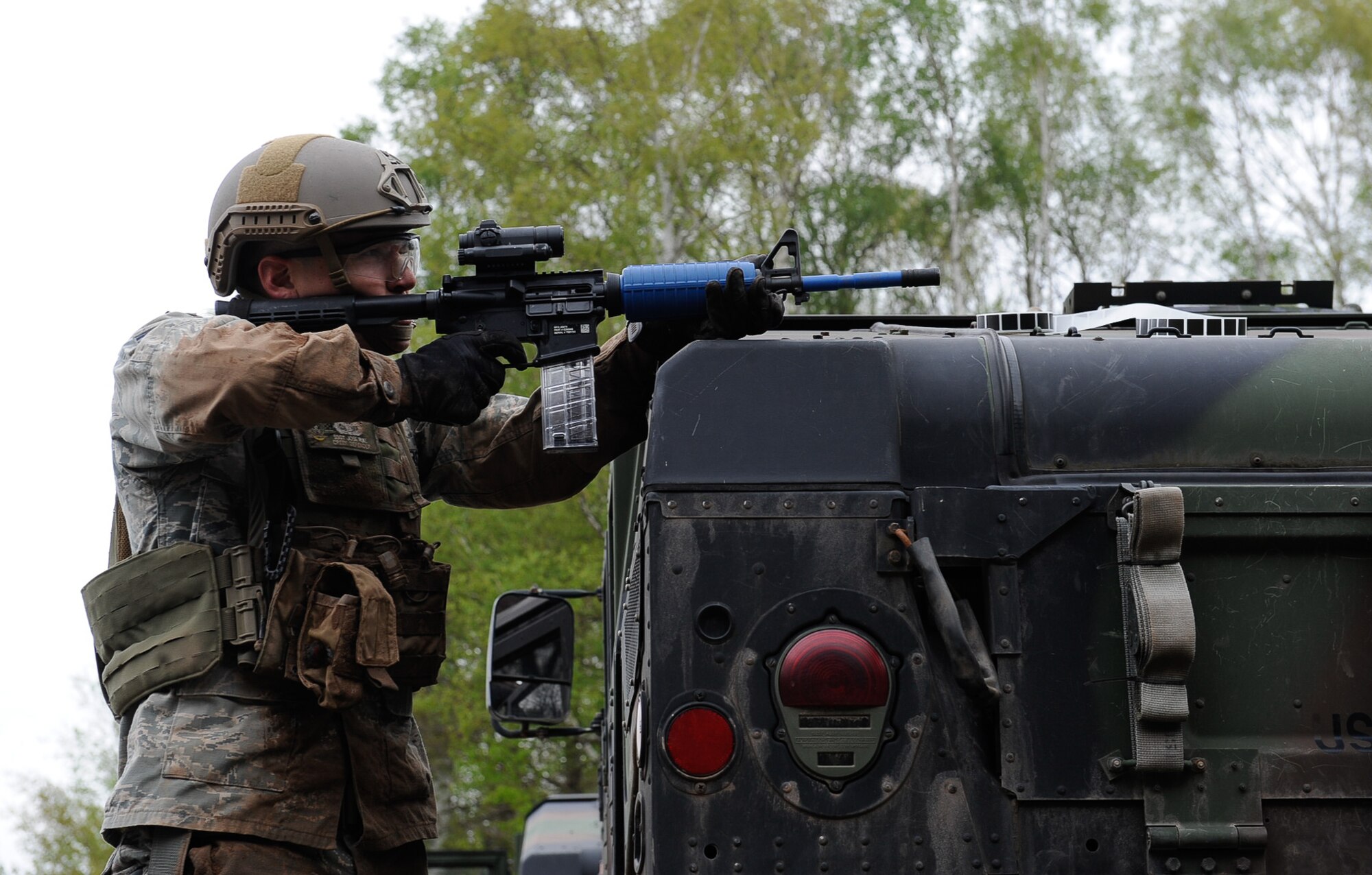 Staff Sgt. Jose Ruiz, 435th Security Forces Squadron Ground Combat Readiness Training Center instructor, fires an M4 over a Humvee during the 435th Contingency Response Group Olympics on Ramstein Air Base, Germany, May 5, 2017. The 435th CRG Olympics was an event that helped to build morale, good comradery, and provide training for Airmen across the group. (U.S. Air Force photo by Airman 1st Class Savannah L. Waters)