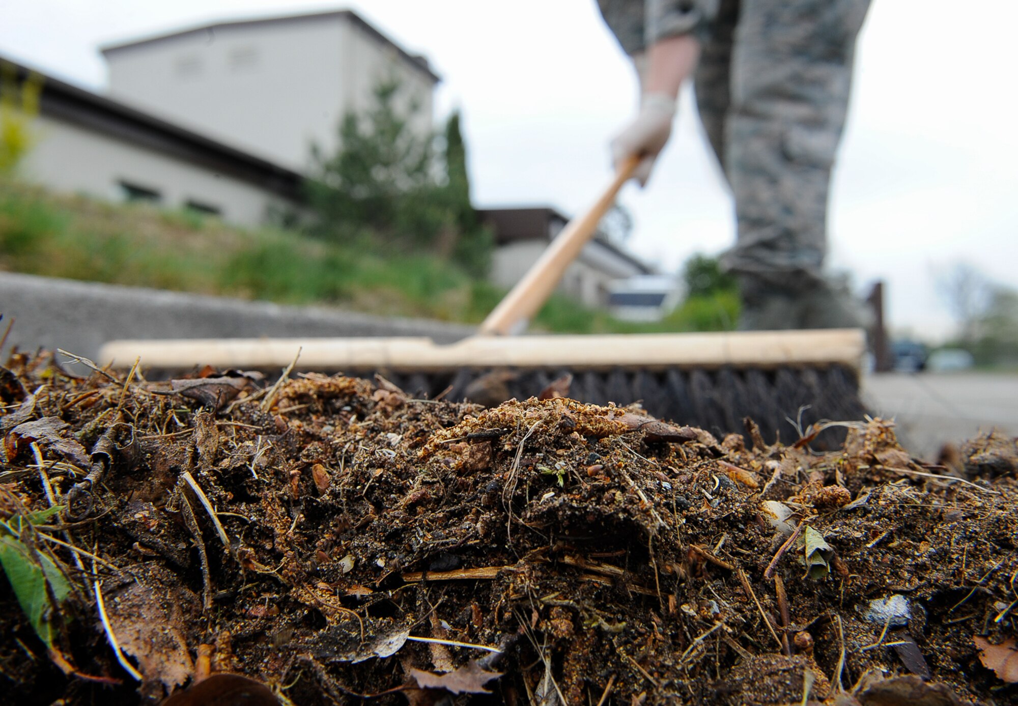 An Airman sweeps during ‘Clean Where You Work’ at Ramstein Air Base, Germany, May 2, 2017. Clean Where You Work is a base pride event designating time specifically for the upkeep of facilities and the surrounding area to improve working environments. The cleaning area of responsibility extends 100 feet in all directions from buildings and includes nearby parking lots and sidewalks. (U.S. Air Force photo by Airman 1st Class Savannah L. Waters)