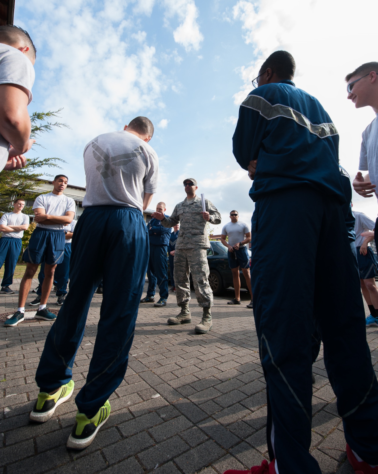 Staff Sgt. Arian Olomi, 86th Civil Engineer Squadron airman dorm leader, speaks with Airmen prior to a 'Clean Where You Live' event at Ramstein Air Base, Germany, May 3, 2017. Clean Where You Live is a day designated for the cleaning of common areas around military family housing and dormitories. (U.S. Air Force photo by Airman 1st Class Savannah L. Waters)