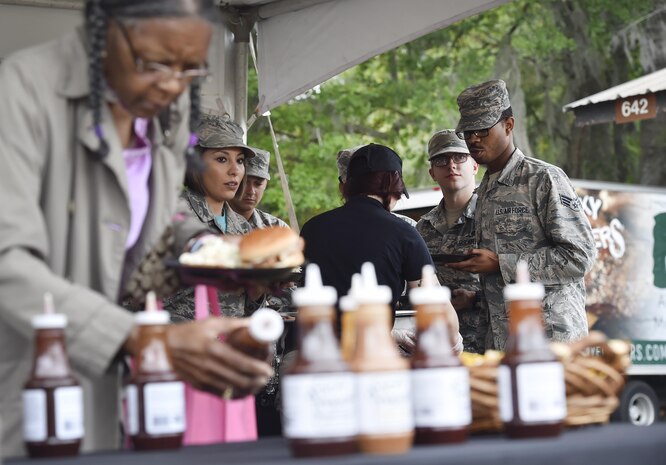 Servicemembers, civilians and their families attend a base picnic at Joint Base Charleston, S.C., May 5, 2017. Attendees were provided free meals and able to participate in various activities including face painting, wall rock climbing, live music and a Military Working Dog demonstration. 