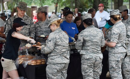 Servicemembers, civilians and their families attend a base picnic at Joint Base Charleston, S.C., May 5, 2017.  Attendees were provided free meals were and able to participate in various activities including face painting, wall rock climbing, live music and a Military Working Dog demonstration.