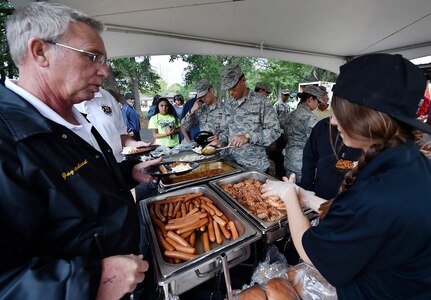 Servicemembers, civilians and their families attend a base picnic at Joint Base Charleston, S.C., May 5, 2017.  Attendees were provided free meals and were able to participate in various activities including face painting, wall rock climbing, live music and a Military Working Dog demonstration. 