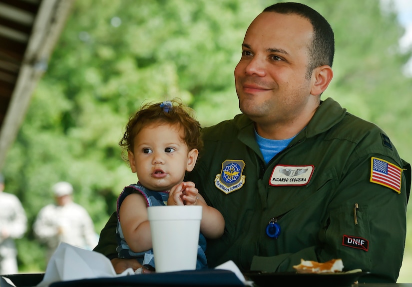 U.S. Air Force Capt. Ricardo Sequeira, 628th Medical Group and Flight Surgeon for the 14th Airlift Squadron, holds his one year old daughter, Maria, during a base picnic at the Air Base Picnic Grounds May 5, 2017, at Joint Base Charleston, S.C. Attendees were provided free meals and able to participate in various activities including face painting, wall rock climbing, live music and a Military Working Dog demonstration. 