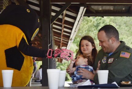 U.S. Air Force Capt. Ricardo Sequeira, right, 628th Medical Group and Flight Surgeon for the 14th Airlift Squadron, and his daughters Sofia, 10 years old, and Maria, one year old, meet the Charleston Battery soccer team mascot during a base picnic at the Air Base Picnic Grounds May 5, 2017, at Joint Base Charleston, S.C. Attendees were provided free meals and were able to participate in various activities including face painting, wall rock climbing, live music and a Military Working Dog demonstration.