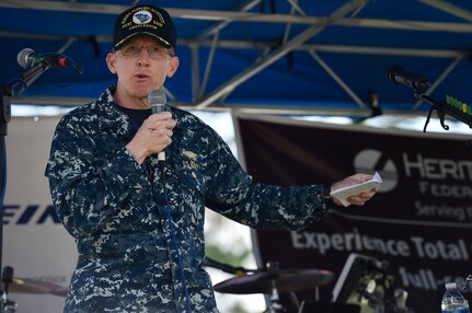 U.S. Navy Capt. Robert Hudson, Joint Base Charleston deputy commander, speaks to service members and their families during a base picnic at the Air Base Picnic Grounds May 5, 2017, at Joint Base Charleston, S.C. Attendees were provided free meals and were able to participate in various activities including face painting, wall rock climbing, live music and a Military Working Dog demonstration.