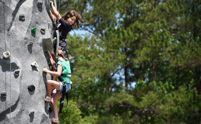 Sofia, 10 years old, top, Eliza, 7 years old, bottom, both daughters of U.S. Air Force Capt. Ricardo Sequeira, 628th Medical Group and 14th Airlift Squadron flight surgeon, climb a rock wall during a base picnic at the Air Base Picnic Grounds May 5, 2017, at Joint Base Charleston, S.C. Attendees were provided free meals and were able to participate in various activities including face painting, wall rock climbing, live music and a Military Working Dog demonstration.