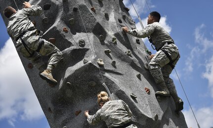 Airmen of the 628th Logistics Readiness Squadron, race up a rock wall during a base picnic at the Air Base Picnic Grounds May 5, 2017, at Joint Base Charleston, S.C. Attendees were provided free meals and were able to participate in various activities including face painting, wall rock climbing, live music and a Military Working Dog demonstration. 