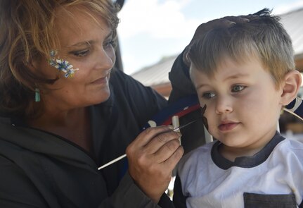 Jacobi, 3 years old  and son of U.S. Air Force Airman 1st Class Collin Dobbel, 628th Civil Engineer Squadron operations management apprentice, gets his face painted during a base picnic at the Air Base Picnic Grounds May 5, 2017, at Joint Base Charleston, S.C. Attendees were provided free meals and were able to participate in various activities including face painting, wall rock climbing, live music and a Military Working Dog demonstration.
