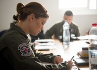 Staff Sgt. Shaina Buller, 86th Aeromedical Evacuation Squadron technician, takes notes during a preflight briefing for a patient movement exercise on Ramstein Air Base, May 4, 2017. The 86th AES practiced transporting simulated patients in a realistic setting, ensuring that they are prepared to perform real-world aeromedical evacuation at a moment's notice. (U.S. Air Force photo by Senior Airman Elizabeth Baker/Released)