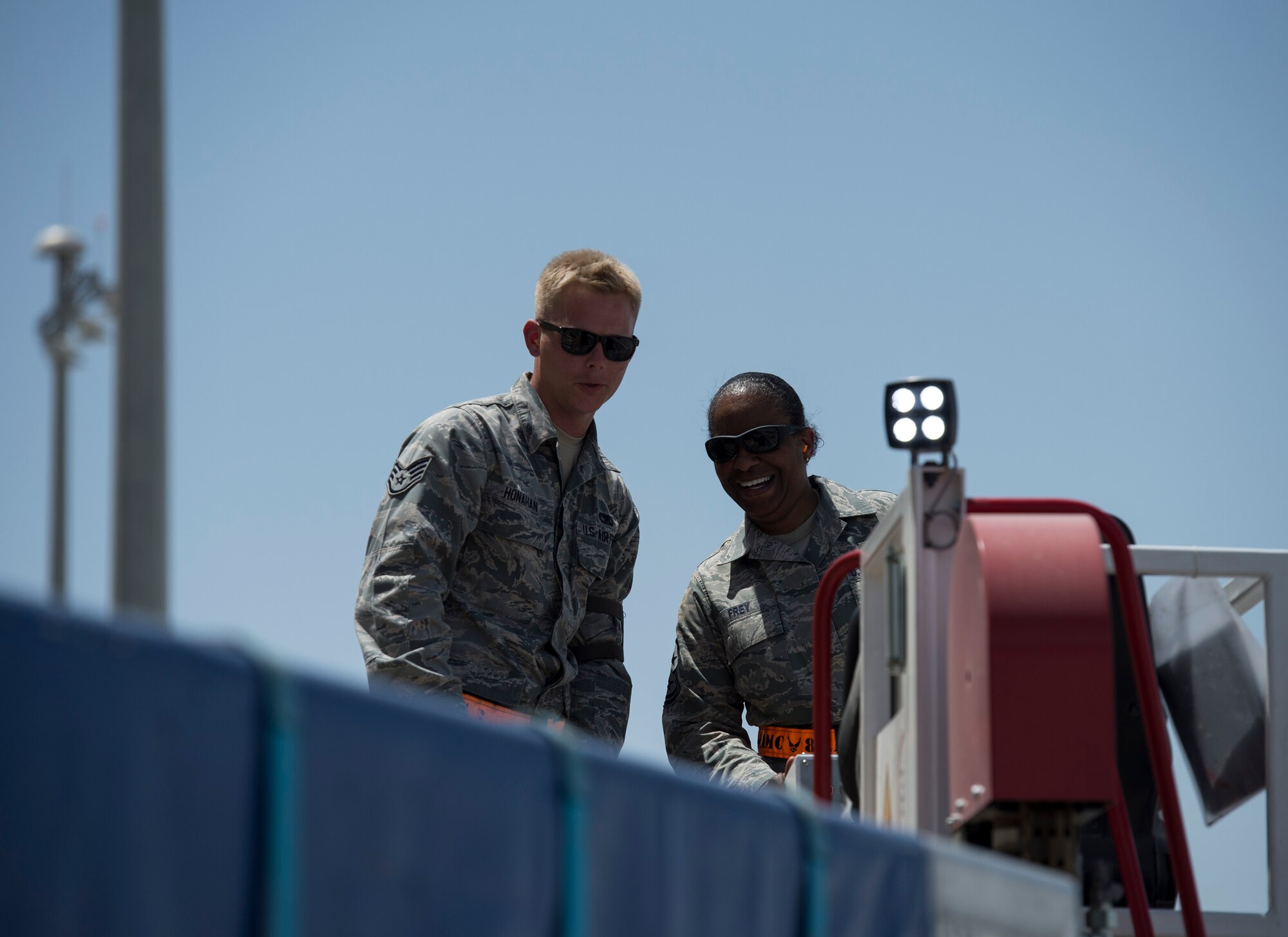 U.S. Air Force Chief Master Sgt. Shelina Frey, Command Chief Master Sergeant for Air Mobility Command, right, operates a lower lobe loader with the help of Staff Sgt. Alexander Honahan with the 8th Expeditionary Air Mobility Squadron at Al Udeid Air Base, Qatar, May 6, 2017. Frey was accompanied by Chief Master Sgt. Mark Redden, Command Chief with the 521st Air Mobility Operations Wing and made several stops throughout the 8th Expeditionary Air Mobility Squadron sections, providing an opportunity for Airmen to speak about their duties and ask questions.  (U.S. Air Force photo by Tech. Sgt. Amy M. Lovgren)