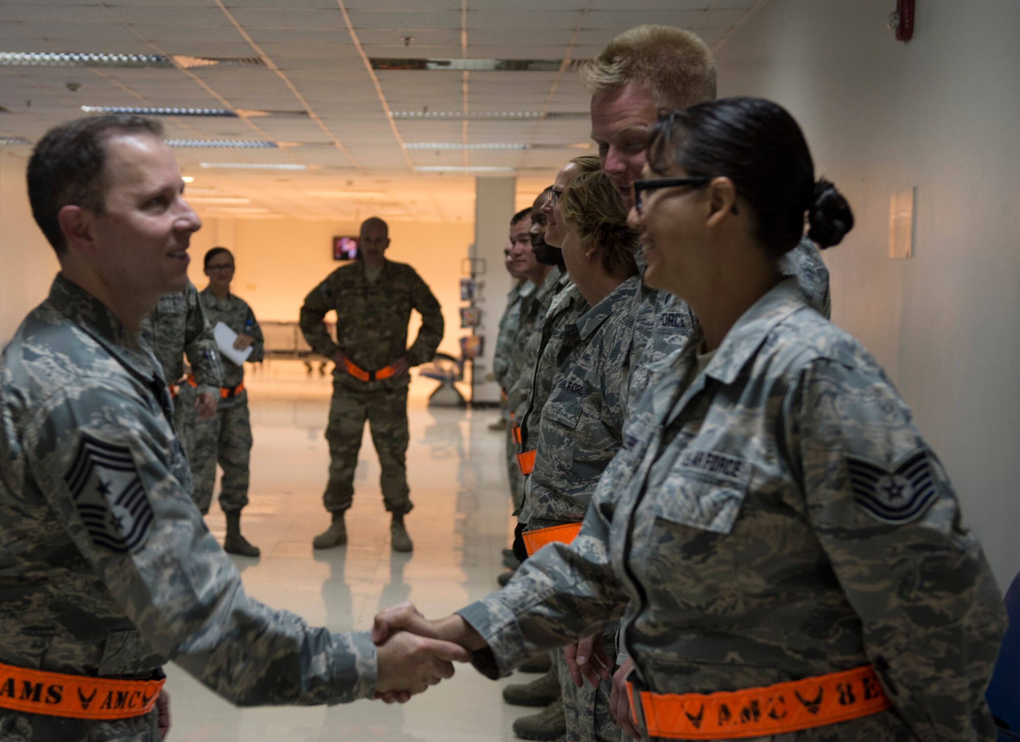 U.S. Air Force Chief Master Sgt. Mark Redden, Command Chief with the 521st Air Mobility Operations Wing at Ramstein Air Force Base, Germany, shakes the hand of a member from the 8th Expeditionary Air Mobility Squadron at Al Udeid Air Base, Qatar, May 6, 2017. Redden was accompanied by Chief Master Sgt. Shelina Frey, Command Chief Master Sergeant for Air Mobility Command and made several stops throughout the 8th Expeditionary Air Mobility Squadron sections, providing an opportunity for Airmen to speak about their duties and ask questions.  (U.S. Air Force photo by Tech. Sgt. Amy M. Lovgren)