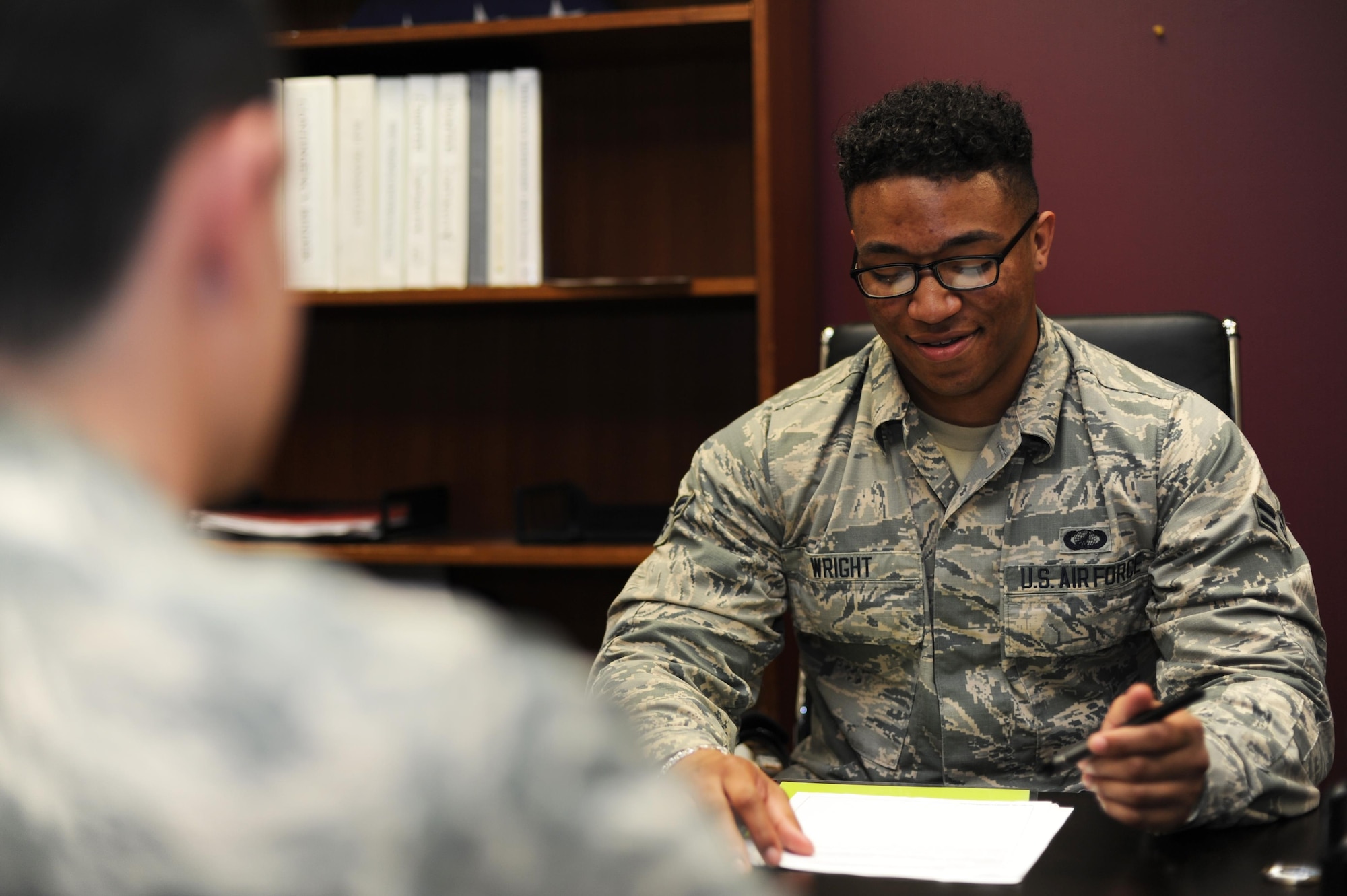 Airman 1st Class Rahsaan Wright, 19th Comptroller Squadron financial services technician, assists a customer May 9, 2017, at Little Rock Air Force Base, Ark. Wright was selected as the Combat Airlifter of the Week for his willingness to help his peers and putting customers first. (U.S. Air Force photo by Airman 1st Class Grace Nichols)
