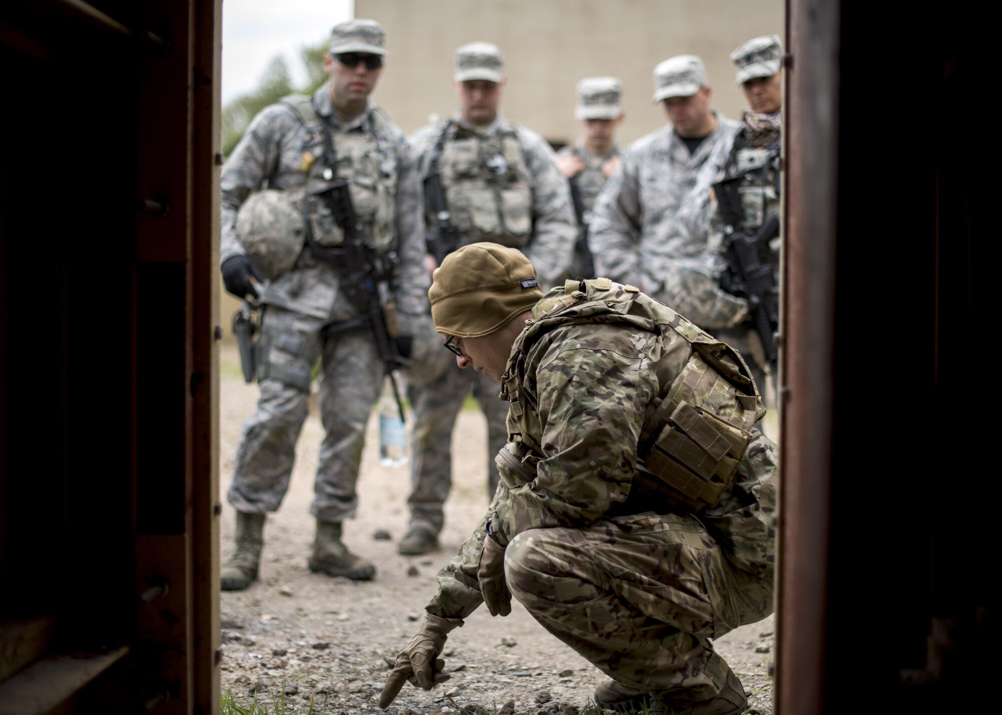 A 48th Civil Engineer Squadron Explosive Ordnance Disposal Airman briefs 48th Security Forces Squadron Airmen prior to the improvised explosive device training during a training exercise at the Stanford Training Area, England, April 21. The two-day training exercise included practicing skills such as patrolling, clearing buildings and improvised explosive devise familiarization. (U.S. Air Force photo/Senior Airman Malcolm Mayfield)
