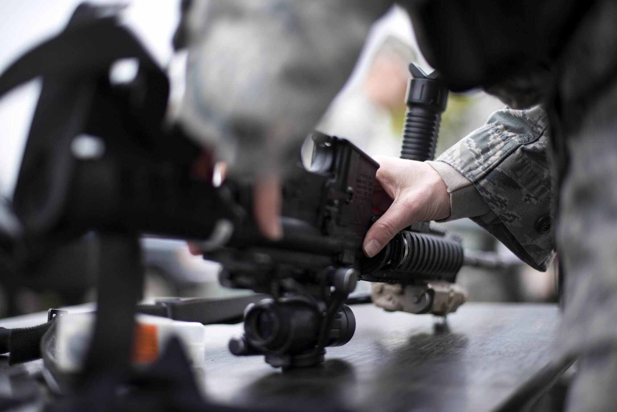 A 48th Security Forces Squadron member prepares their weapon during a training exercise at the Stanford Training Area, England, April 21. The two-day training exercise included practicing skills such as patrolling, clearing buildings and improvised explosive devise familiarization. (U.S. Air Force photo/Senior Airman Malcolm Mayfield)