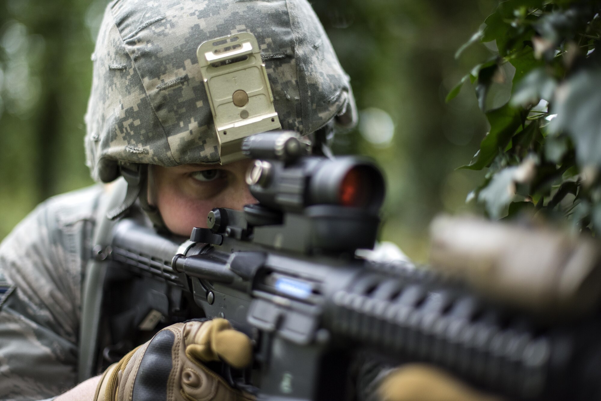 A 48th Security Forces Squadron member looks down the sights of his weapon during a training exercise at the Stanford Training Area, England, April 21. The two-day training exercise included practicing skills such as patrolling, clearing buildings and improvised explosive devise familiarization. (U.S. Air Force photo/Senior Airman Malcolm Mayfield)
