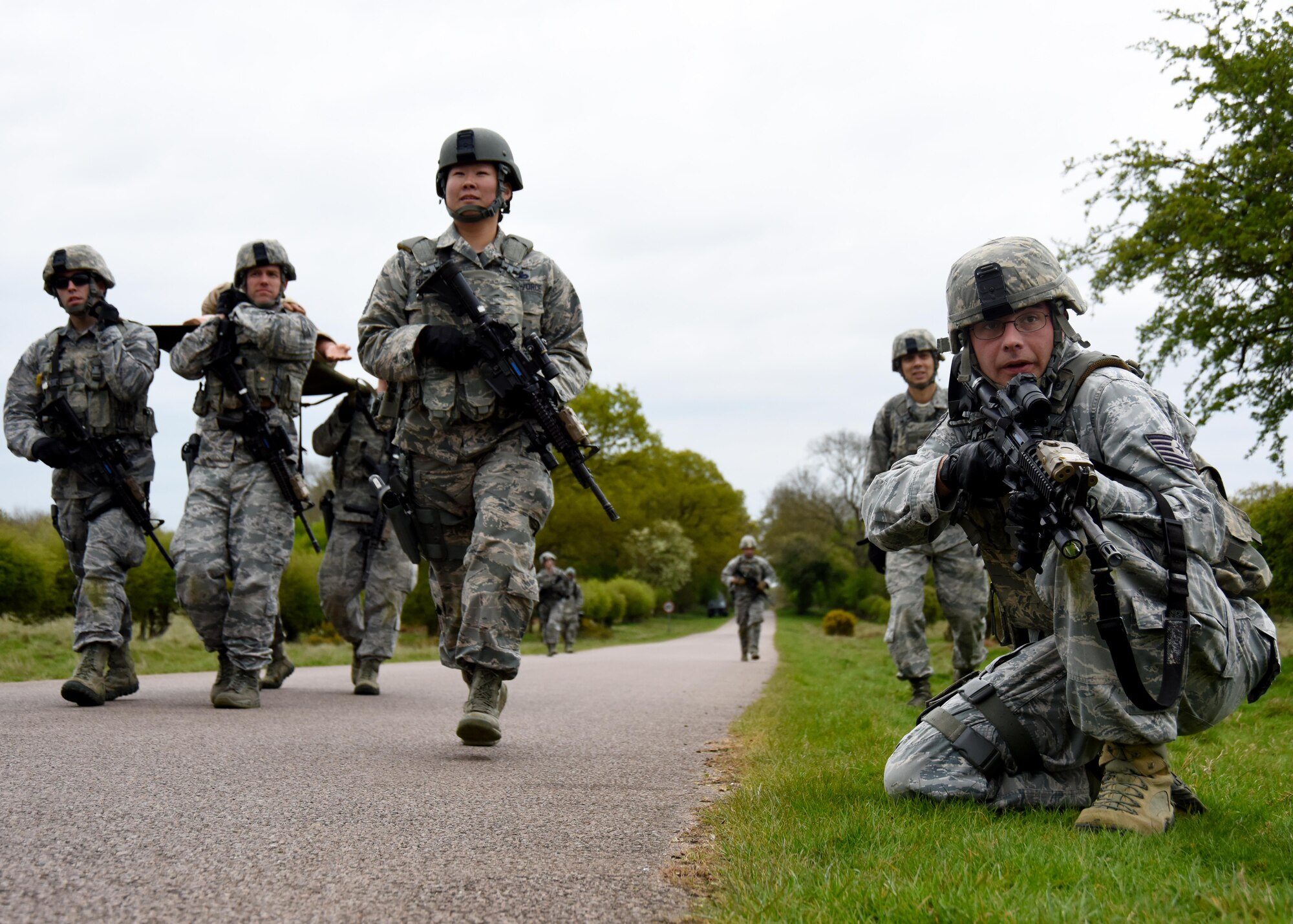 48th Security Forces Airmen remain vigilant on the final stretch of their patrol during a training exercise at the Stanford Training Area, England, April 21. The Airmen took turns protecting and carrying a simulated injured service member. (U.S. Air Force photo/Airman 1st Class Abby L. Finkel)