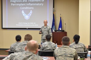 Col. Chol Chong, 59th Dental Training Squadron Periodontics Residency Program director, speaks to an audience during a continuing education dental conference at Joint Base Charleston, S.C., May 5, 2017. Chong discussed the diagnosis and treatment procedures of peri-implant inflammatory conditions. The conference served as a forum to discuss growing trends and the way ahead for the Air Force dental community. Topics focused primarily on dental implants and procedures for treating potential complications that may arise after a procedure.