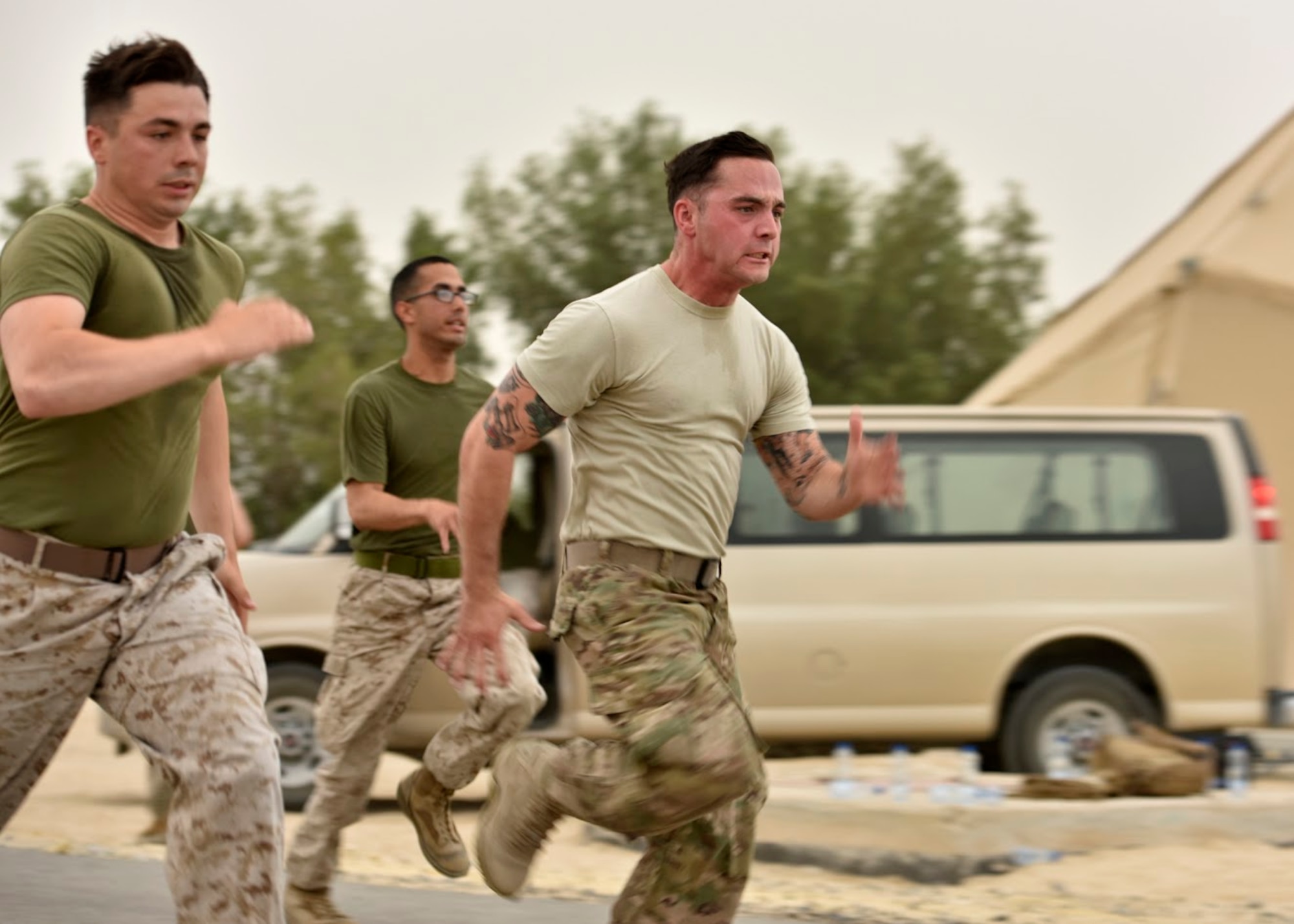 U.S. Air Force Staff Sgt. Anthony Diaz (right), 407th Expeditionary Logistic Readiness Squadron ground transportation journeyman, races Marines during a Corporal’s Course physical training session April 29, 2017. The corporal’s course is a 14-day formal training event designed to educate Marine corporals on the duties and responsibilities of an NCO. Deployed Airmen were granted the opportunity to attend the course, which is an eligibility requirement for Marines before promoting to the rank of sergeant. (U.S. Air Force photo by Senior Airman Ramon A. Adelan)