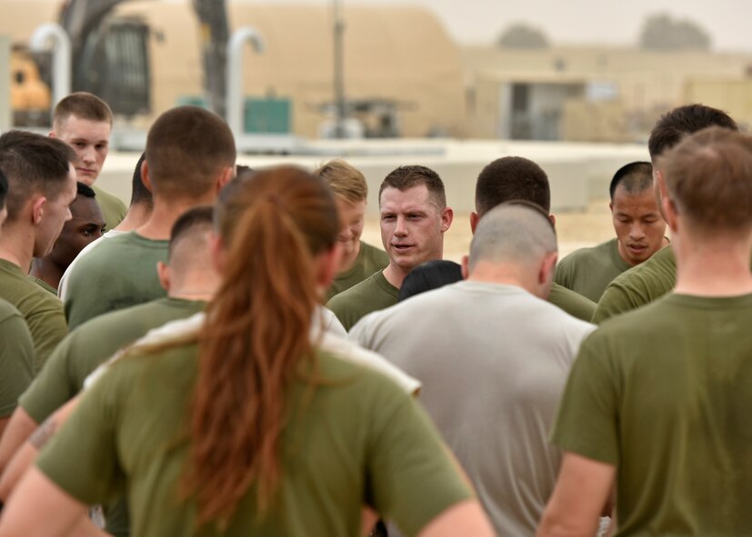 Marine Corps Staff Sgt. Ryan Prosper, a 1st Battalion 7th Marines and Corporal’s Course instructor, mentors Airmen and Marines after a Corporal’s Course physical training session April 29, 2017. The corporal’s course is a 14-day formal training event designed to educate Marine corporals on the duties and responsibilities of an NCO. Deployed Airmen were granted the opportunity to attend the course, which is an eligibility requirement for Marines before promoting to the rank of sergeant. (U.S. Air Force photo/Senior Airman Ramon A. Adelan)