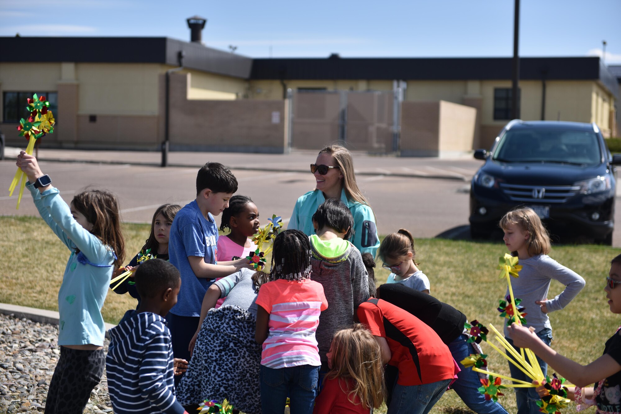 Children from the Malmstrom Youth Center place pinwheels around fences to help raise awareness on child abuse prevention April 13, 2017. National Provider Appreciation Day May 12 recognizes the impact child care providers have on the community. (U.S. Air Force photo/Master Sgt. Chad Thompson) 