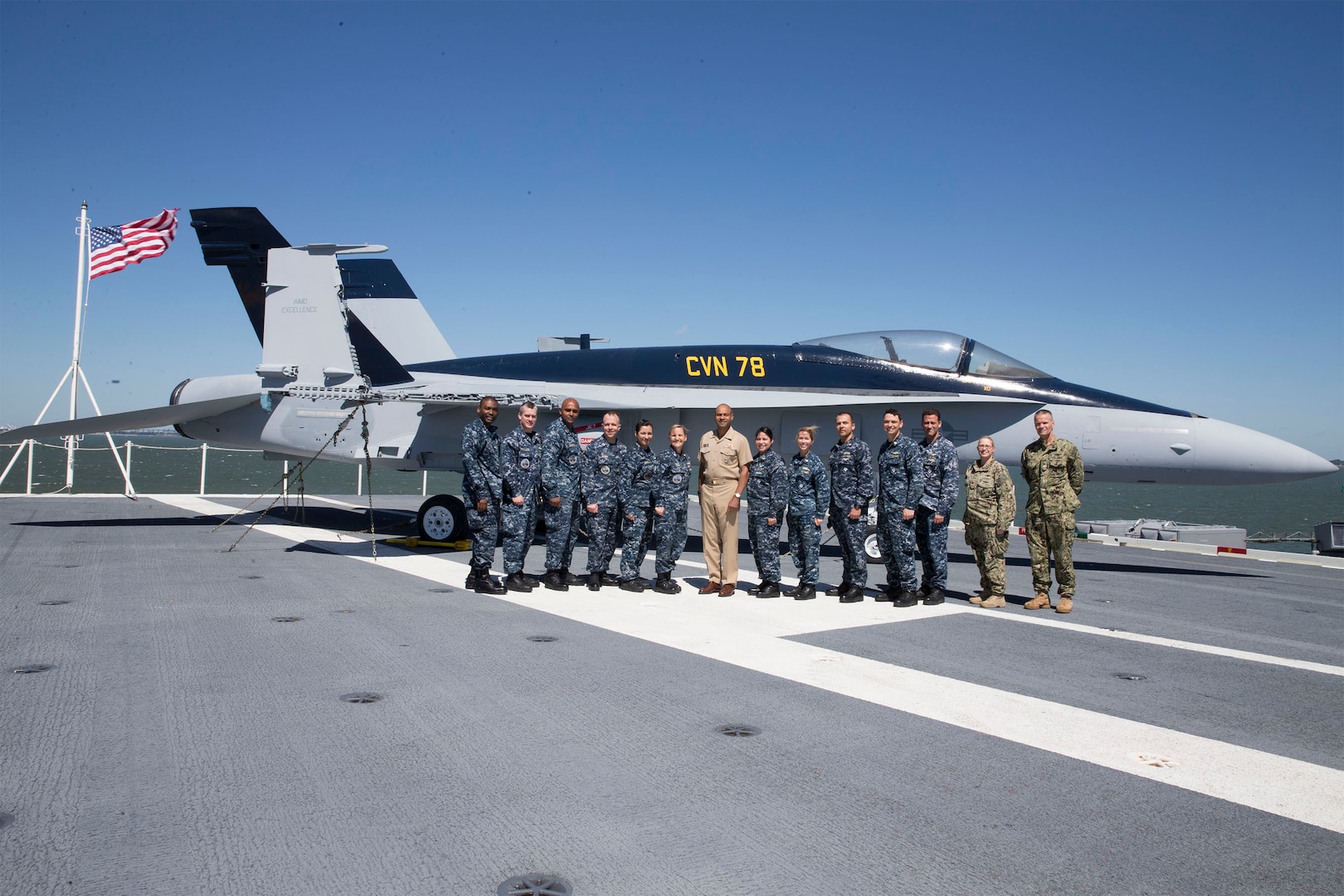 Navy Rear Adm. Vincent Griffith (center), director of DLA Logistics Operations, stands with the USS Ford’s supply officers, and Navy Capt. Harry Thetford (right), commander of DLA Distribution Norfolk, during his visit on May 2.