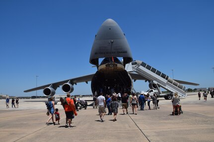 Visitors to the 433rd Airlift Wing’s Family Day climb aboard the Alamo Wing's first C-5M Super Galaxy, "The City of San Antonio" May 7, 2017 at Joint Base San Antonio-Lackland, Texas.  (U.S. Air Force photo by Tech. Sgt. Carlos J. Trevino)