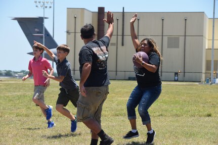 Master Sgt. Roxanne Mc Cabe,  a 433rd Force Support Squadron wing career advisor, gets a high-five from her spouse, John, for making a catch for an out during the inaugural kickball tournament during the 433rd Airlift Wing’s Family Day May 7, 2017 at Joint Base San Antonio-Lackland, Texas.  Teams representing various squadrons and agencies from within Alamo Wing played in the double elimination tournament for a trophy and bragging rights. (U.S. Air Force photo by Tech. Sgt. Carlos J. Trevino) 