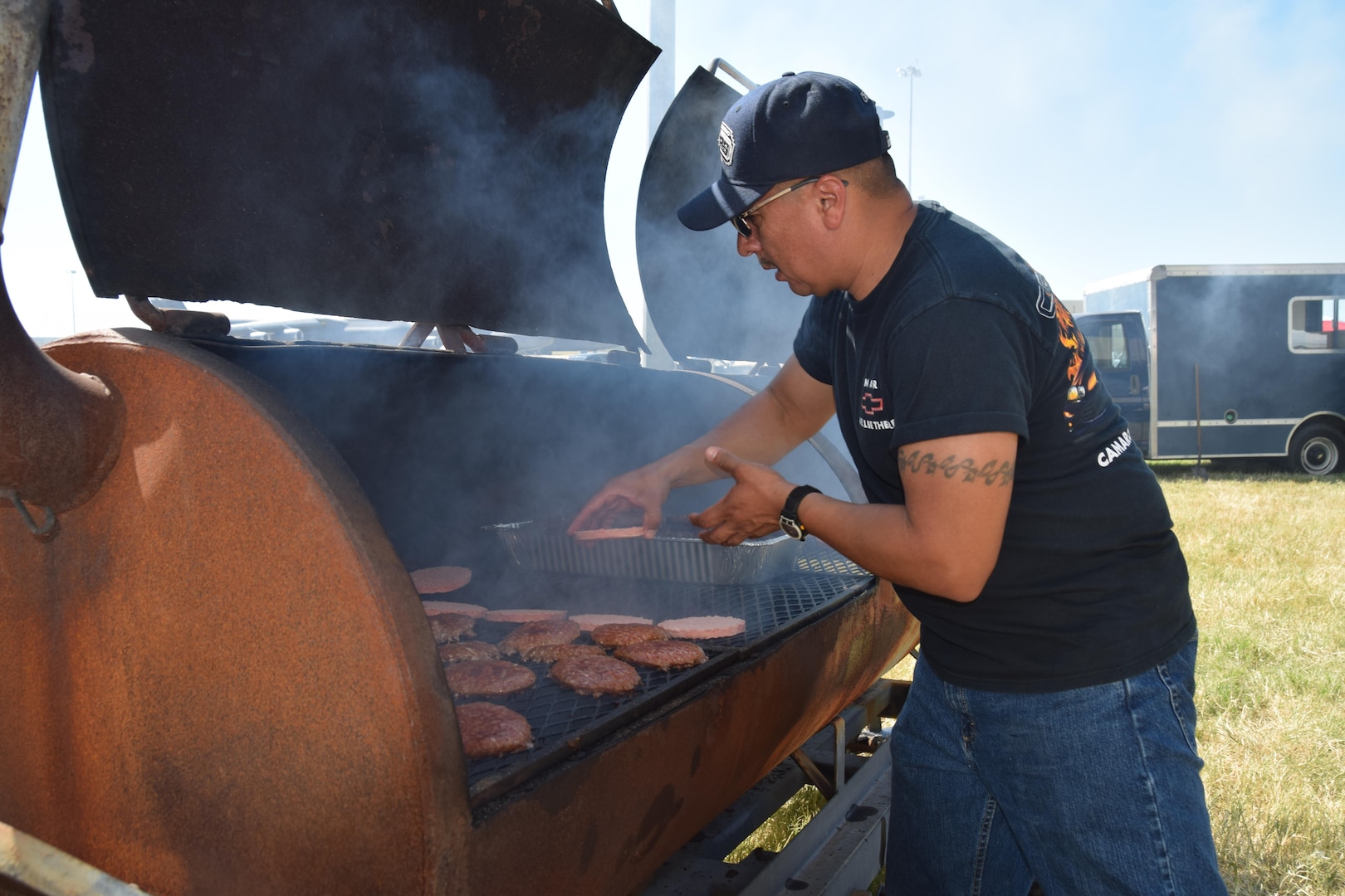 Tech. Sgt. Andrew Preciado, a 433rd Maintenance Squadron hydraulic shop supervisor, cooks burgers at the 433rd Airlift Wing’s Family Day May 7, 2017 at Joint Base San Antonio-Lackland, Texas.  Families were treated to free food, drinks, aircraft displays, kid-friendly events and the inaugural kickball tournament. (U.S. Air Force photo by Tech. Sgt. Carlos J. Trevino) 