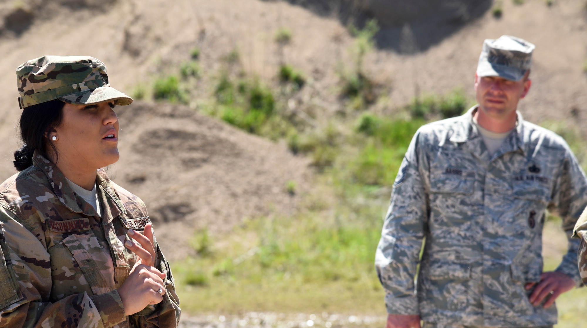 Staff Sgt. Makayla McConnell, 114th Security Forces Squadron security response team member, instructs her fellow Airmen on proper tactical squad movements May 6, 2017, on a training site near Sioux Falls S.D. McConnell is the first female from the 114th Security Forces Squadron to attend and complete Combat Leadership School. (U.S. Air National Guard photo by Staff Sgt. Duane Duimstra/Released)