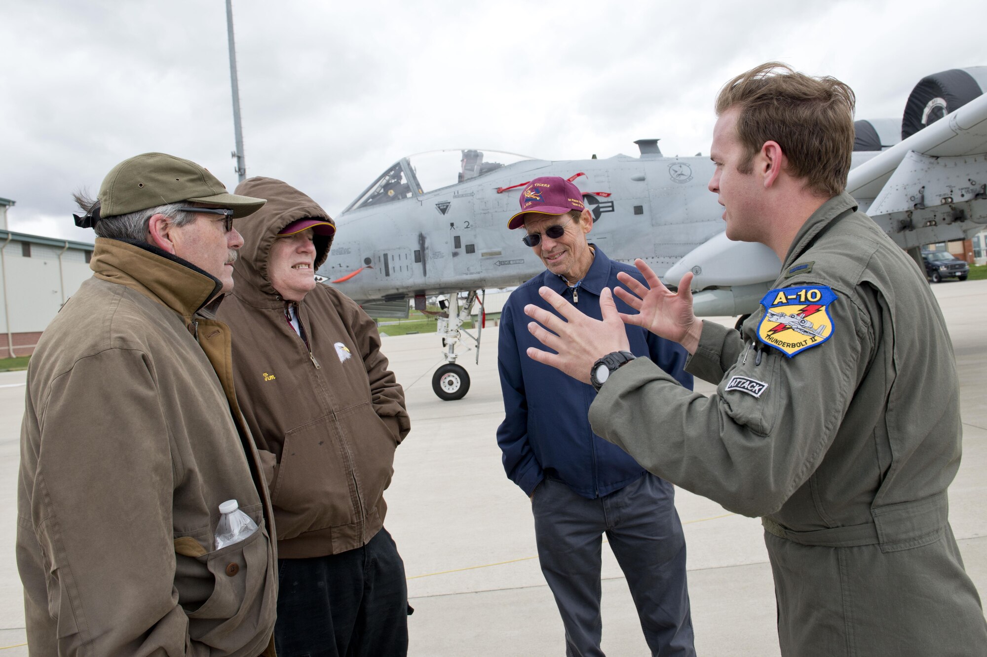 First Lt Andrew Paterson, an A-10 pilot assigned to the 23dFG, speaks with relatives of the late Peter Atkinson the day prior to Atkinson's re-interment ceremony in Martinsburg, W.Va. The 23d FG is charged with carrying on the heritage of the Flying Tigers, the unit Atkinson was assigned to when he died while flight testing a P-40 aircraft. Atkinson had been in a unmarked grave in Hawaii for more that 70 years and was laid to rest at his family plot April 8. Four A-10's from the 23d FG flew a missing man formation over the ceremony to honor Atkinson. (U.S. Air National Guard photo by Senior Master Sgt. Emily Beightol-Deyerle)