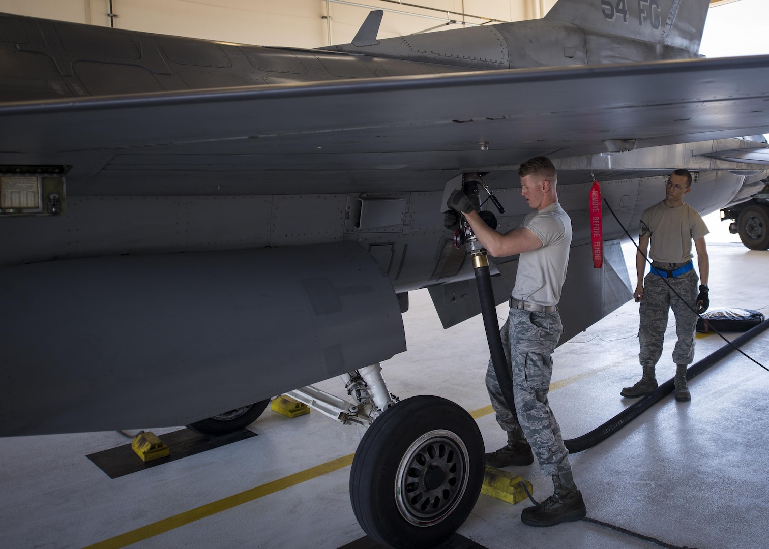 Airman 1st Class Derek King, a 54th Aircraft Maintenance Unit F-16 crew chief, refuels an F-16 Fighting Falcon following a recovery operation at Holloman Air Force Base, N.M. on May 4, 2017. The 54th AMU runs 24 hour operations. Therefore, Holloman’s maintenance Airmen work round-the-clock to keep these aircraft operable, performing a variety of mechanical and technical duties. (U.S. Air Force photo by Airman 1st Class Alexis P. Docherty)